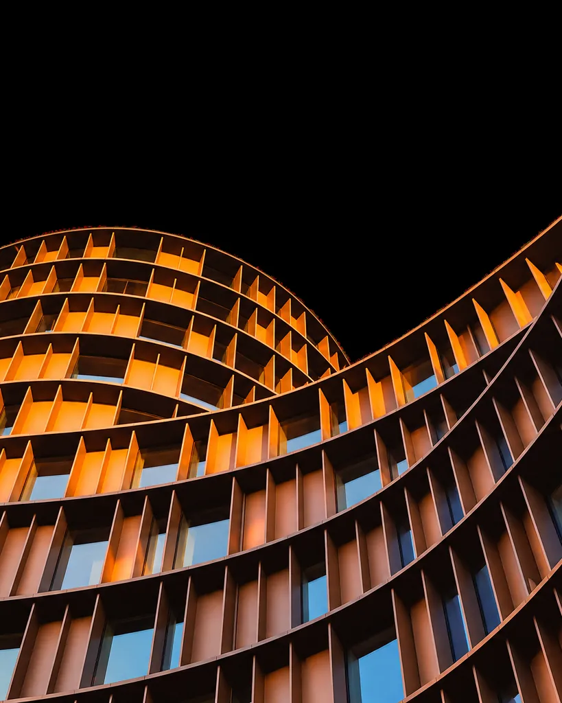 Curved architectural facade glowing at night